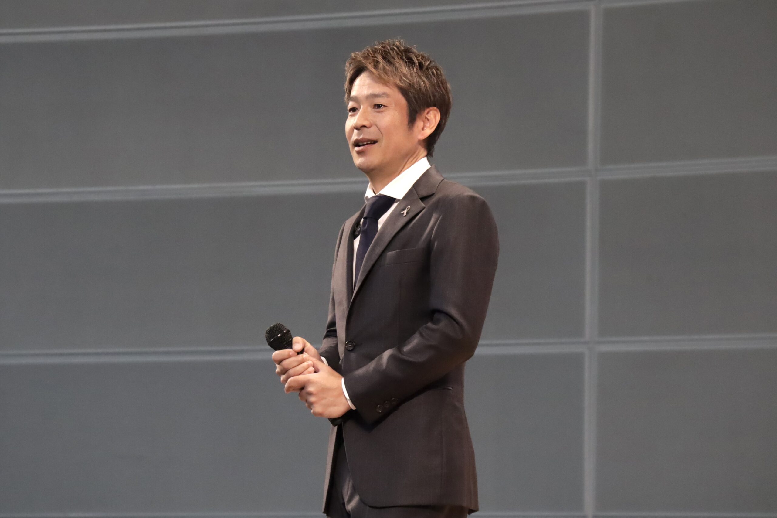 ステージ上で講演を行うフリーアナウンサー清水健